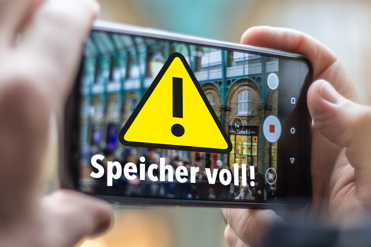 Hand hält Smartphone und macht Foto. Warnhinweis "Speicher voll!" erscheint.