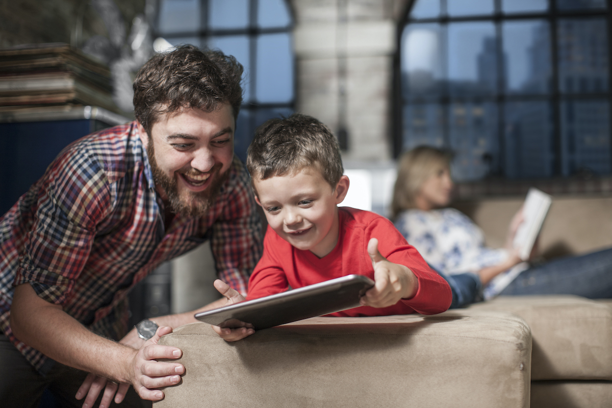 Vater und Sohn spielen auf einem Tablet