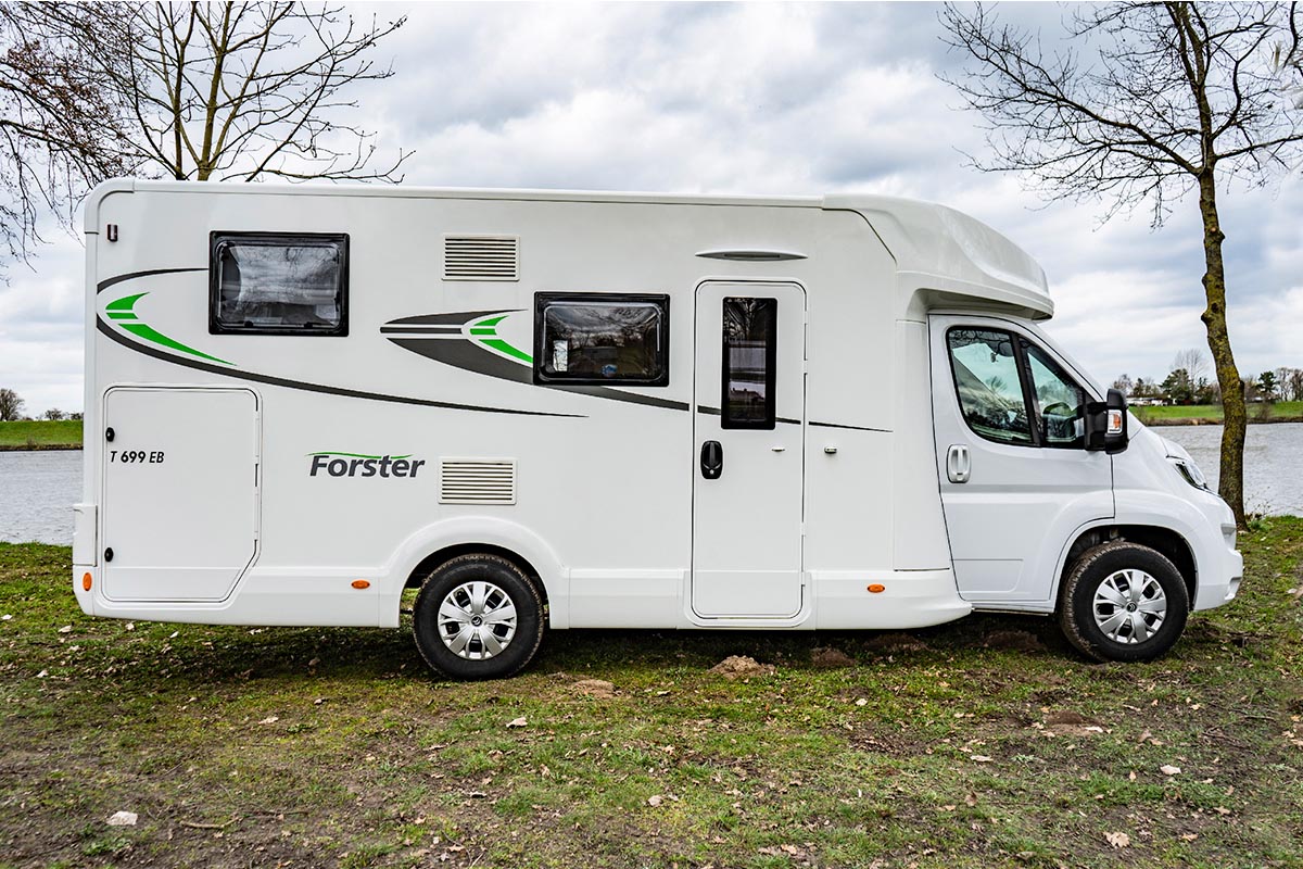 Das teilintegrierte Wohnmobil Forster T 699 EB vor einer Flusslandschaft.