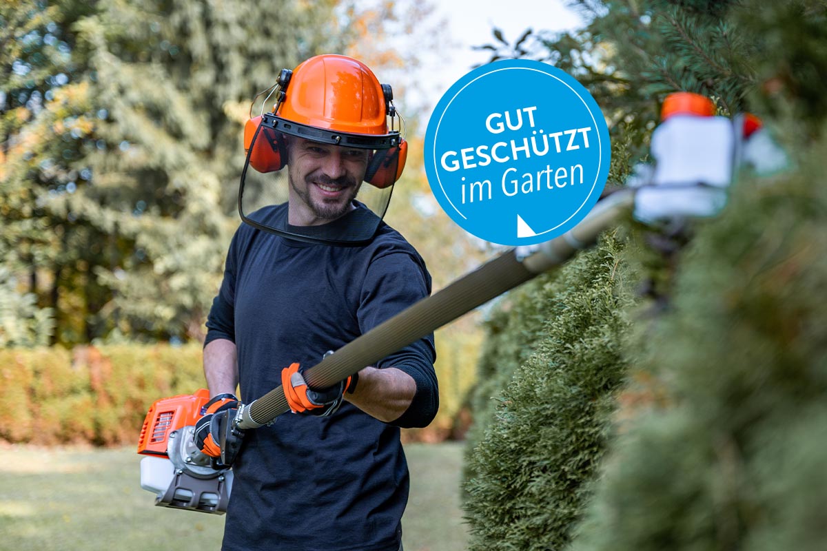 Ein Gärtner, der eine Hecke schneidet