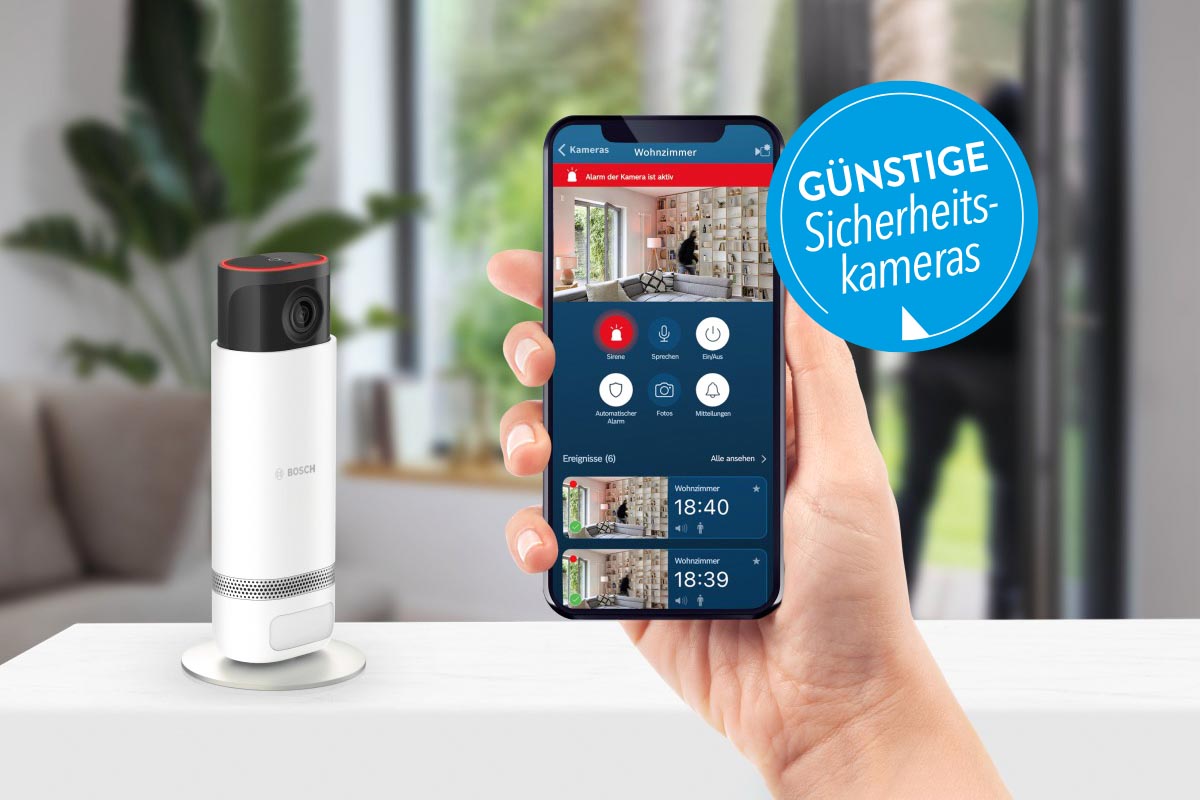 Sicherheitskamera von Bosch neben einem Smartphone mit geöffneter App.