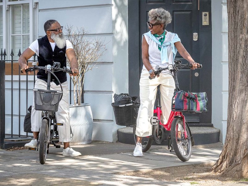 Zwei Personen auf ihren Kompakt-E-Bike, lächeln sich an