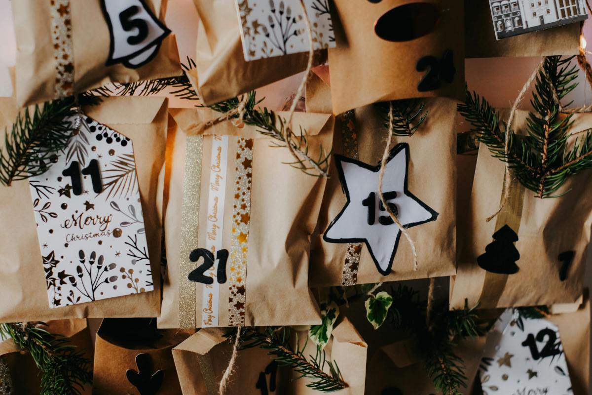 beigefarbene Beutel eines handgemachten Adventskalenders mit Zahlen in Sternchen