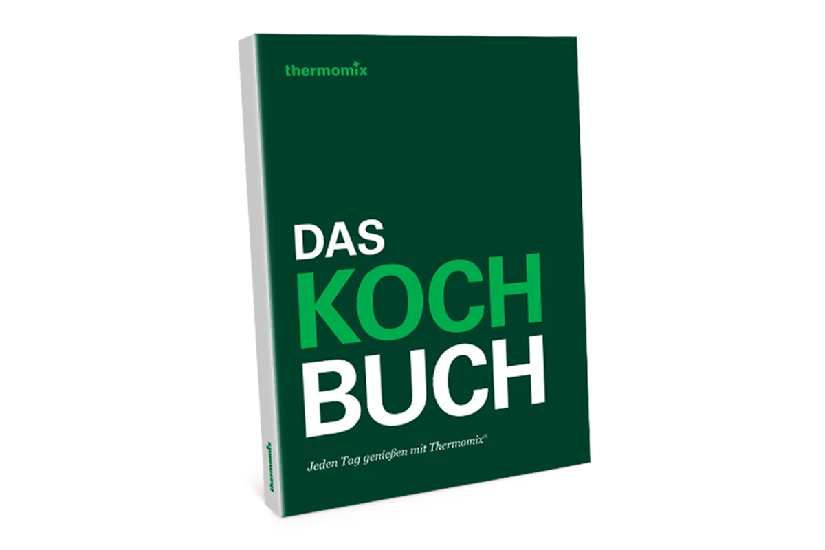 Ein grünes Buch mit der Aufschrift "Thermomix Das Koch Buch" auf weißem Hintergrund